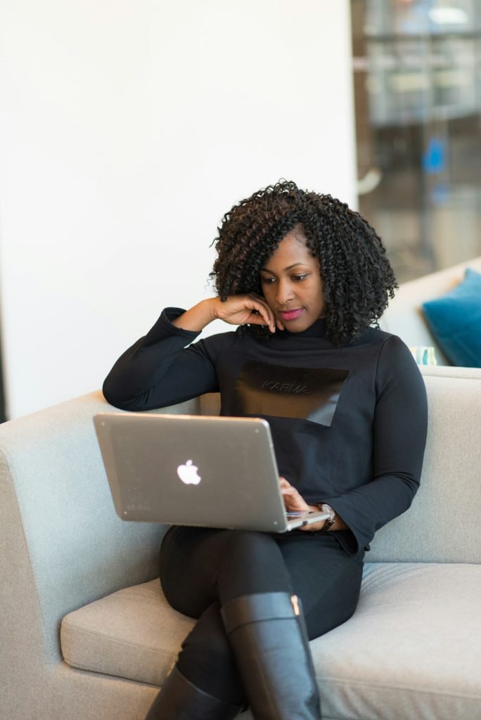 woman-in-black-coat-using-macbook-8jwcwlsbys8